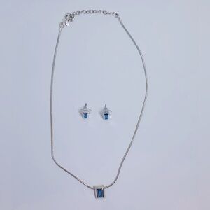 Silver necklace and matching stud earrings with blue stone